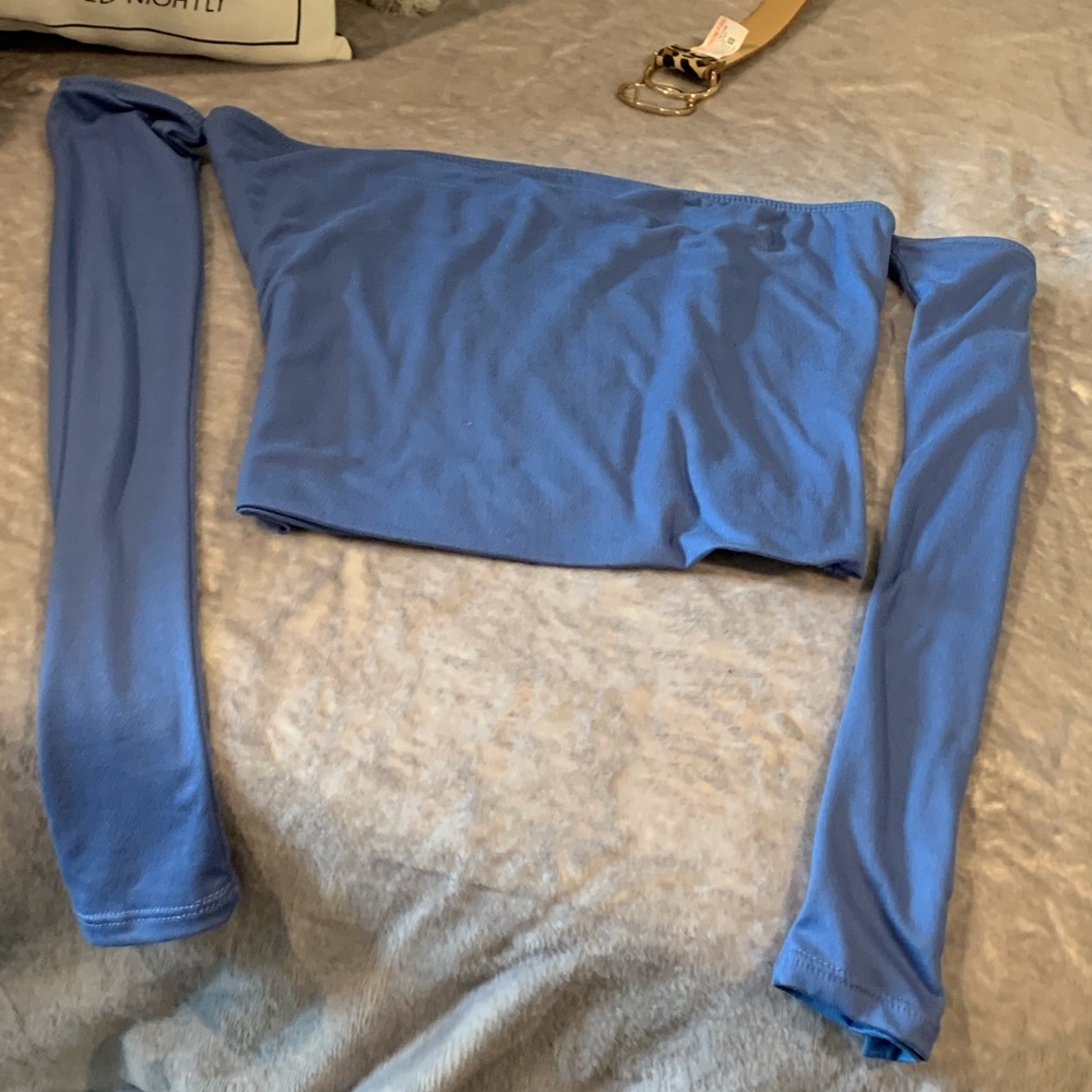 Two crop tops: blue and black long sleeves.